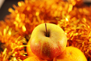 Image showing apple close-up on a background of twinkling garlands