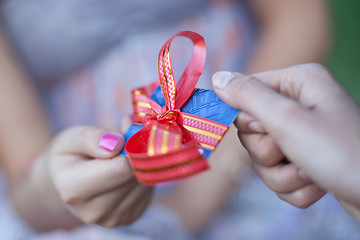 Image showing Credit card with bow as gift to young woman