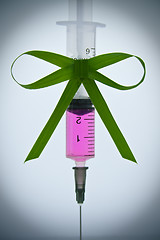 Image showing syringe pink liquid with ribbon of grass