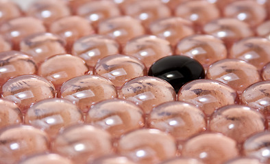 Image showing black glass stone in pink glass stones