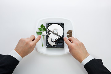 Image showing hard disk cut with a knife man