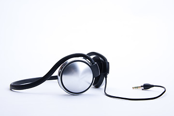 Image showing headphones with plug lie on background