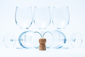 Image showing glass wine stand and lie symmetrically with cork