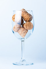 Image showing single glass wine with a corks of bottle