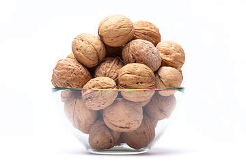 Image showing Walnuts lie in a glass bowl isolated on white