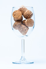 Image showing single glass wine with a corks of bottle