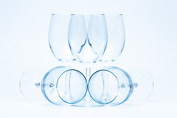 Image showing Empty wine glasses stand and lie symmetrically