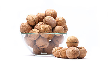 Image showing Walnuts lie in a glass bowl isolated on white