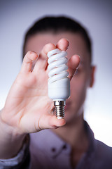 Image showing person holding energy saving lamp
