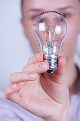 Image showing woman holding electrical lamp