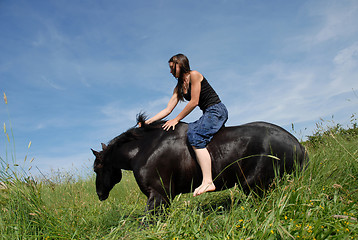 Image showing horse laid down and riding girl