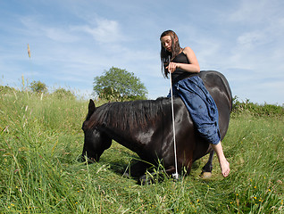 Image showing horse laid down and riding girl