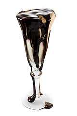 Image showing Icecream in a wine glass with massive amounts of chocolate toppi