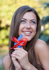 Image showing happy young woman holds credit card in hands
