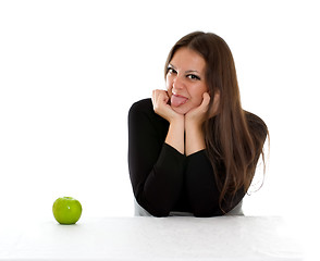 Image showing girl with green apple showing tongue