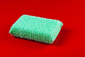 Image showing green sponge on red background