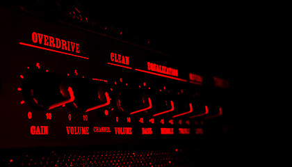 Image showing guitar amplifier control panel in red light