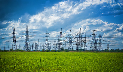 Image showing summer meadow with high-voltage towers