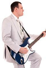 Image showing man in grey suit playing guitar