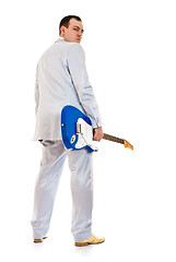 Image showing man in white suit with electric guitar look back