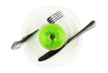 Image showing fork, knife, green apple on white dish