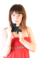 Image showing beautiful girl with black grapes in hand