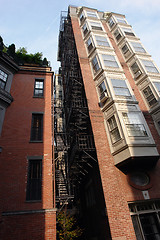 Image showing Tall building with fire escape and bay windows full color