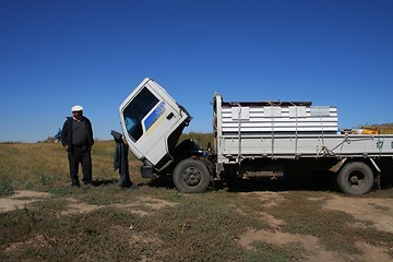 Image showing Man repairing a broken truck