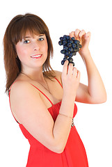 Image showing beautiful girl with black grapes in hand