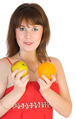 Image showing girl with orange and apple in hands