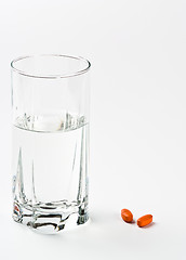 Image showing two pills and glass of water