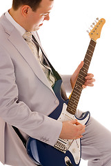 Image showing man in white suit playing guitar