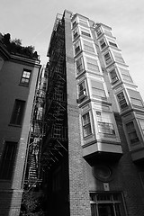 Image showing Tall building with fire escape and bay windows