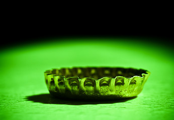 Image showing beer cap closeup on green