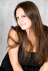Image showing smiling young woman with long brown hair