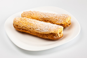 Image showing two eclairs on white dish