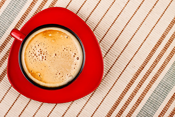 Image showing red coffee cup on tablecloth