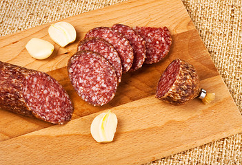 Image showing sausage and garlic on cutting board