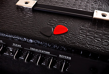 Image showing two plectrums on guitar amplifier
