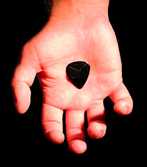 Image showing guitar plectrum in hand