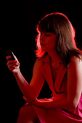 Image showing girl call by cell phone on dark background