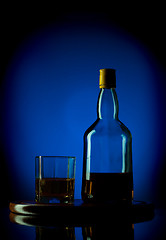 Image showing whiskey bottle and glass on wooden tray