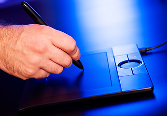 Image showing man's hand on drawing tablet