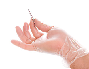 Image showing hand in rubber glove holding tweezers