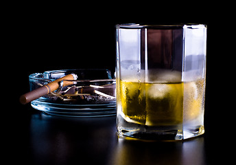 Image showing ashtray full of butts and glass of whiskey