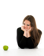 Image showing girl with grimace on her face and green apple