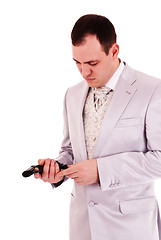 Image showing man in white suit reload the gun