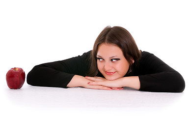 Image showing girl staring at the red apple