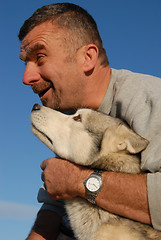 Image showing happy man and husky