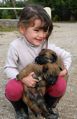 Image showing smiling girl and puppies